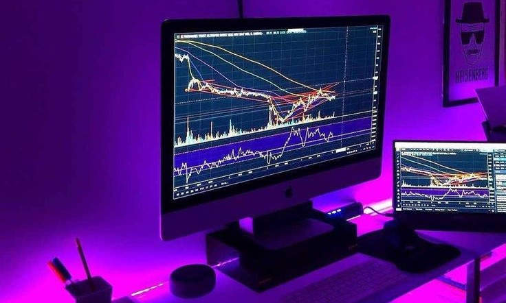 A desk setup with a computer and monitor, suited for analyzing the best forex brokers available.